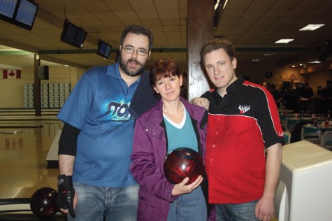 Susan Burkitt, Duffy Lougheed's niece, holds Duffy's bowling ball, accompanied by Ryan Paziuk, left, and Leif Skggedal, two of the bowlers who gathered at the Str1ke Zone recently to raise funds in memory of Lougheed. Allan WISHART/Free Press