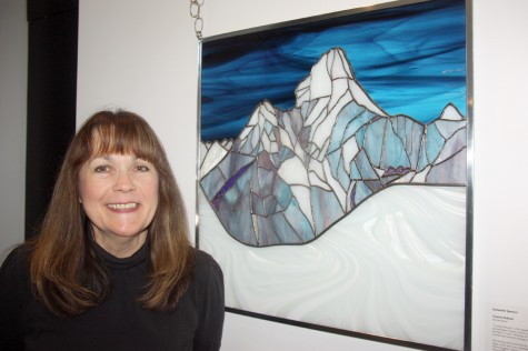 Artist Jeannette Spencer with her work Everest Reborn. The stained glass work which is showing in the group exhibit Rebirth on display at Rustad Gallery in Two Rivers Gallery, has its own amazing story of rebirth. Teresa MALLAM/Free Press