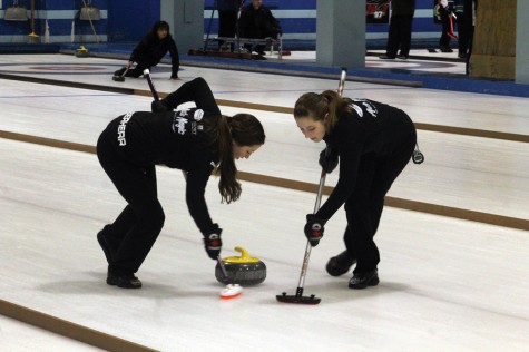 Bailey Eberherr, left, and Erin Ross of the Alyssa Connell rink put some effort into sweeping during the final game of the Ladies Bonspiel at the Prince George Golf and Curling Club on Sunday. The Connell rink downed Julia Shaddick to claim the title. Allan WISHART/Free Press