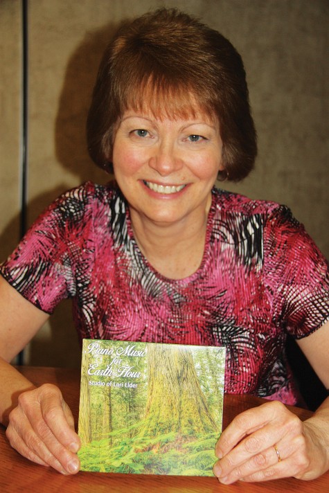 Piano teacher Lori Elder with a new forest-themed CD that will be launched to coincoide with Earth Day. The CD is entitled Piano Music for Earth Hour. Teresa MALLAM/Free Press