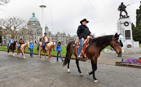 Leaving from the provincial Legislature building in Victoria, Quesnel rancher and veteran Paul Nichols leads a group of fellow veterans on horseback, from left, Nanaimo RCMP Constable John Gilmour, Nanaimo RCMP Constable Mark Smith and Sooke veteran David Ristau on the first leg of the Veterans Foundation Ride Across Canada hat will draw attention to younger military vertans in Canada. Nichols will be joined by other veterans on the eight-month ride from Victoria to Newfoundland. Don DENTON/Victoria News