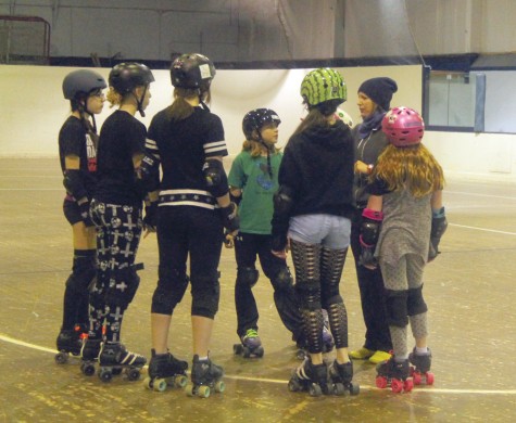 Rated PG Roller Brats coach Yard sale, right, talks to some of the skaters before a recent practice. The Roller Brats are on the track Saturday for a match against Gold Pain City from Quesnel. Allan WISHART/Free Press