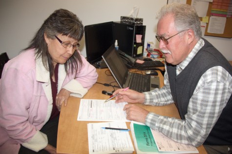 Francisca Leeson talks taxes with long time volunteer Paul Raines on Wednesday at the Salvation Army location. Raines, a retired teacher and principal with School District 57, is participating in the free community income tax preparation program which is geared to helping people with lower incomes. The program runs until the end of April. Google CRA tax clinic locations to find one convenient to you. Teresa MALLAM/Free Press